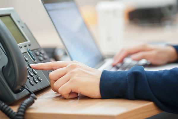 Person dialing on a Cisco phone system