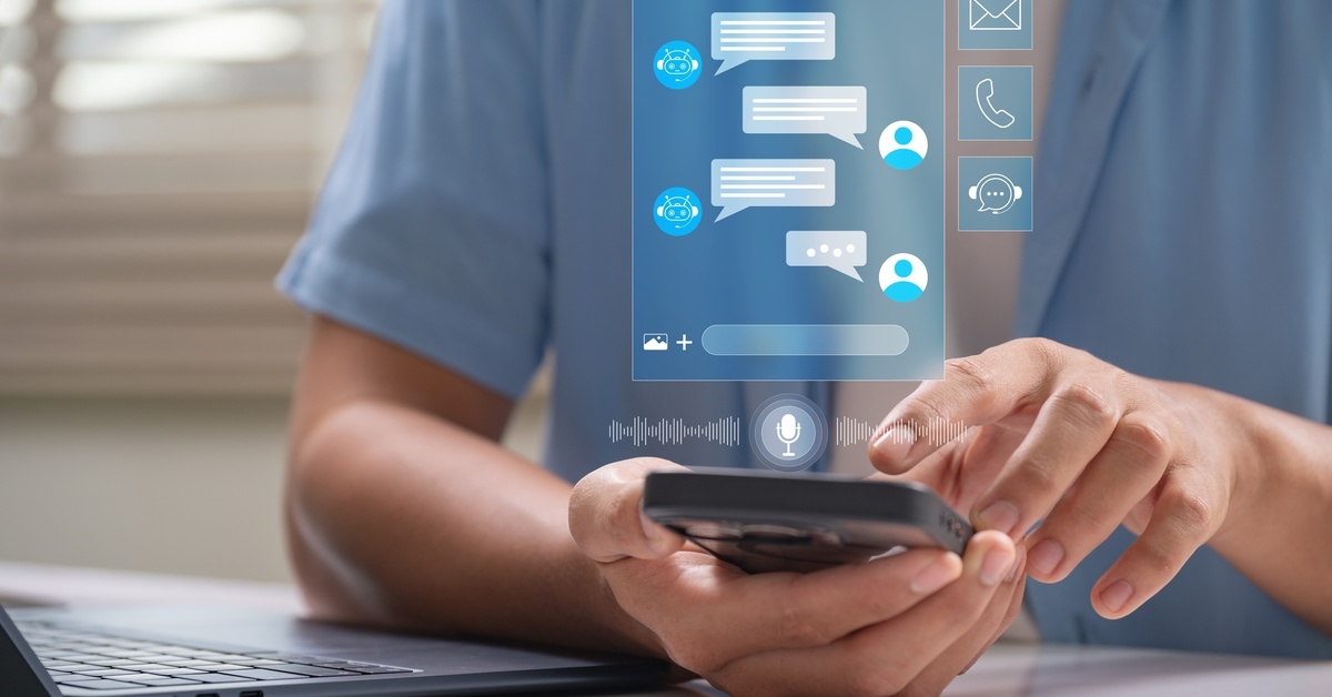 A person holding a smartphone. Above the phone is a chat box showing an AI chatbot conversation.