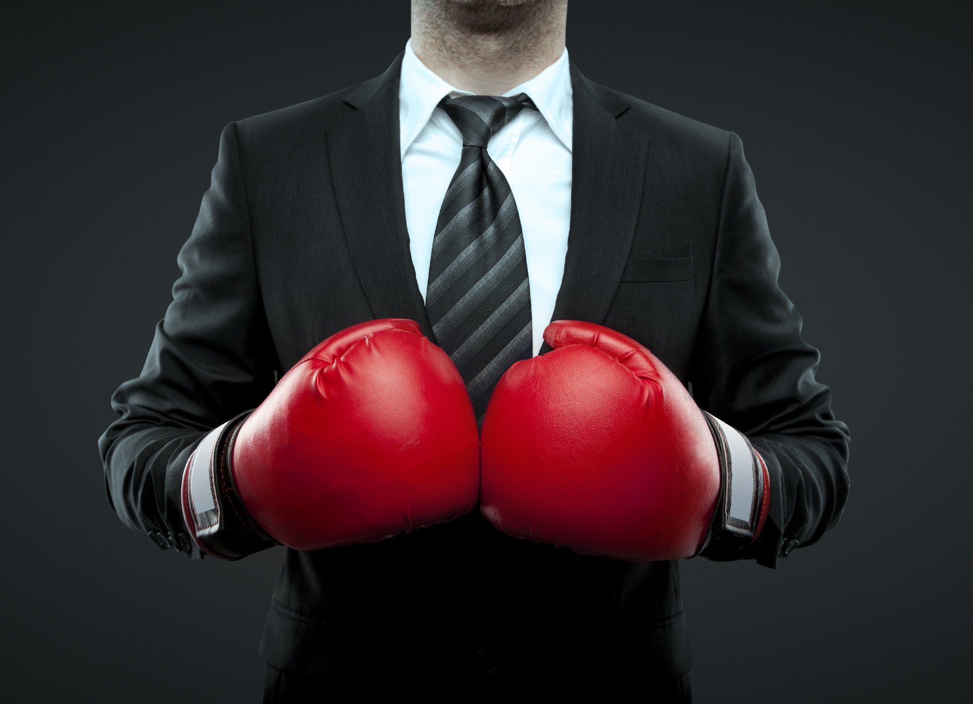 Man in suit with red boxing gloves