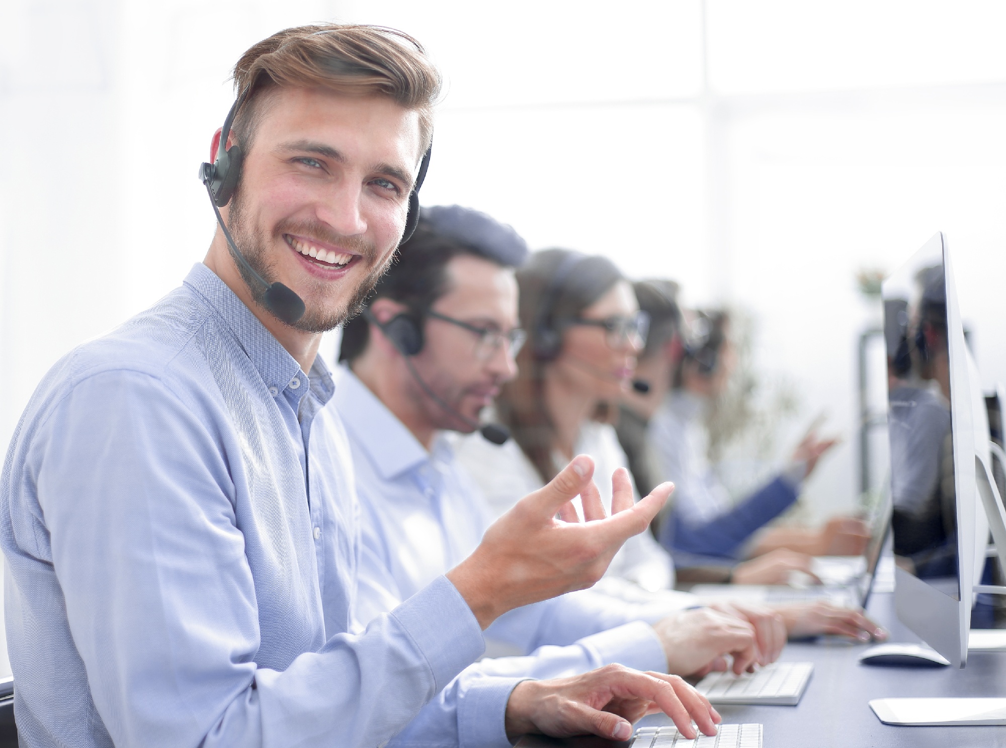 Customer Service Agent smiling with hand held up